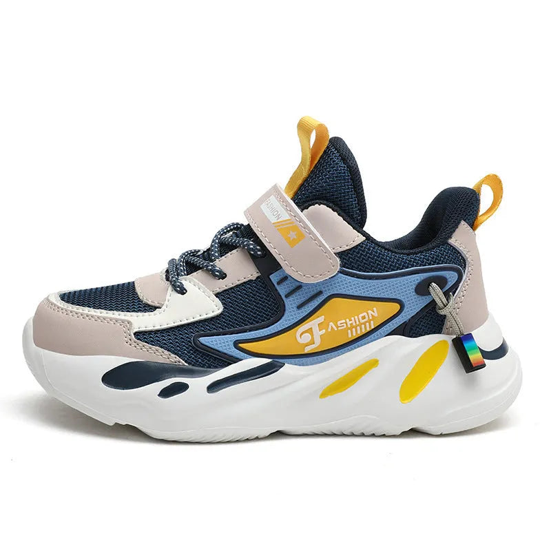 Boys' blue and black platform sports running shoes with Velcro straps on a hard ground surface.