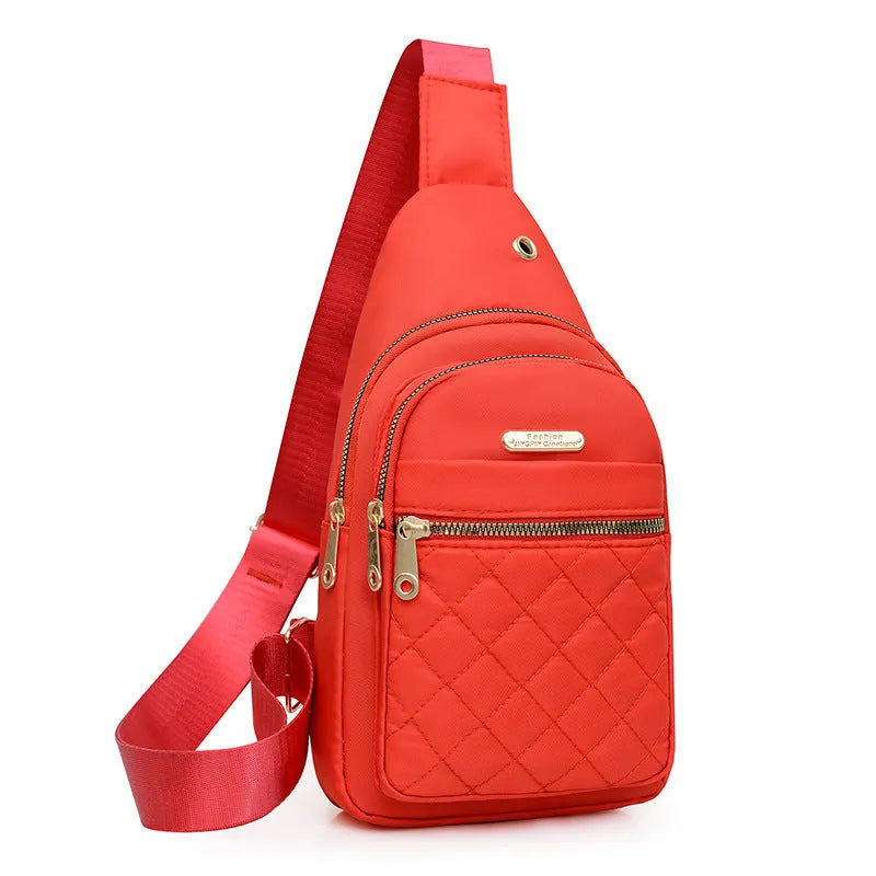 A girl's crossbody sports chest bag in Oxford cloth, shown in a choice of colours including black, dark blue, red, purple, and pink.