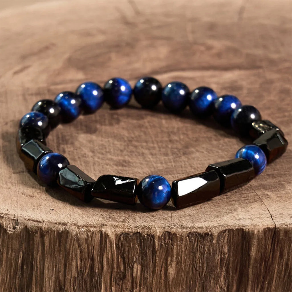 Natural obsidian single ring bracelet with 8mm beads and a metal constellation charm on a white background.