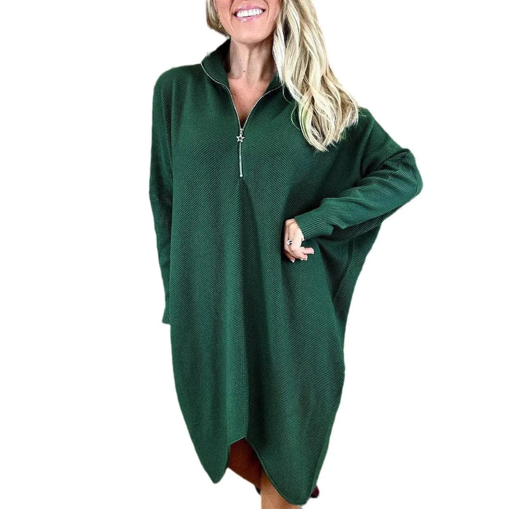 Dark green loose knitted women's dress with full front zipper and raglan sleeves on a hanger.