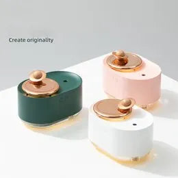Green rotating planet USB humidifier with night light on a wooden desk