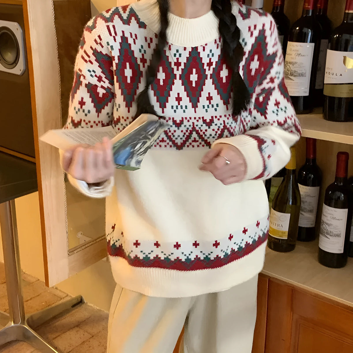 Red and white striped loose retro pullover knitted top with long sleeves on a hanger.