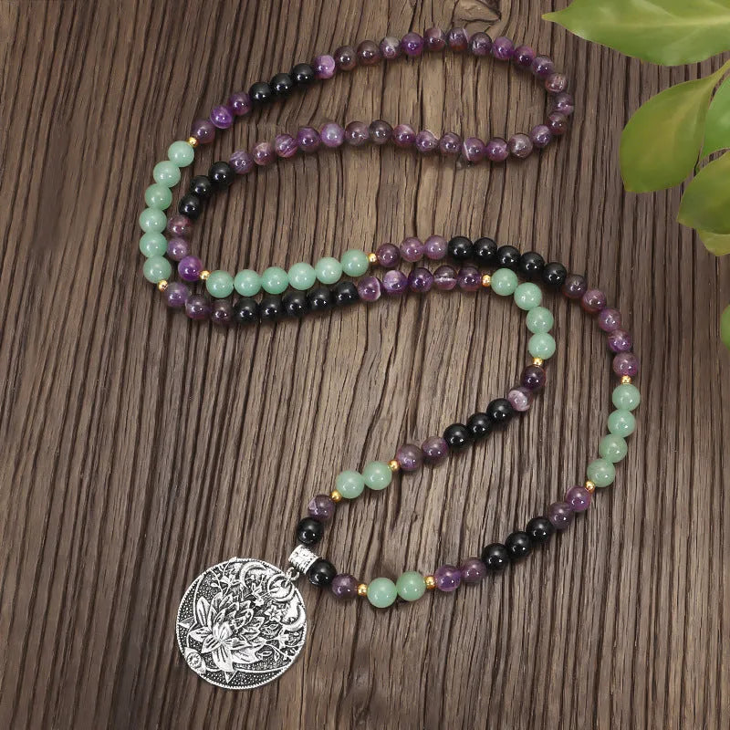 Geometric lotus pendant yoga necklace with stone bead chain and matching bracelet on white background