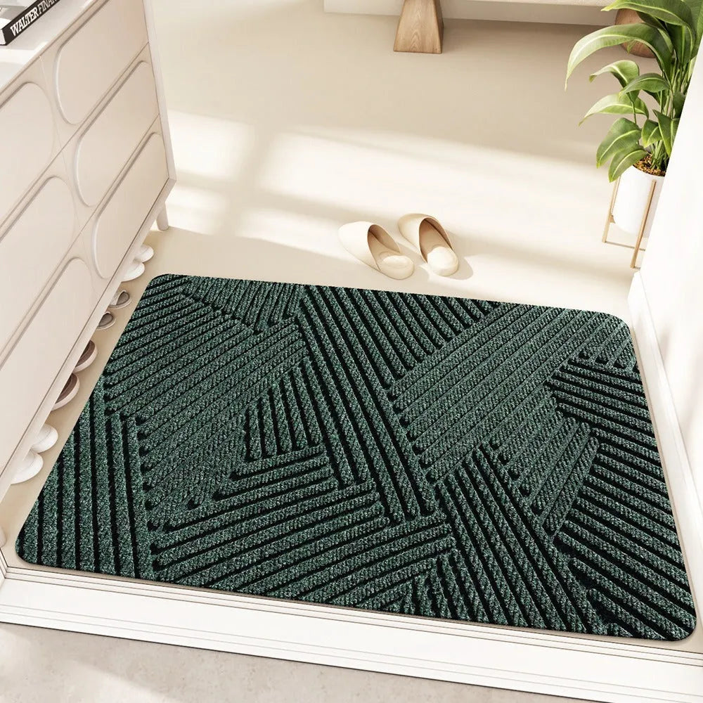 Green alien-shaped floor mat with cartoon pattern, measuring 60 by 90 cm with a wire ring border.