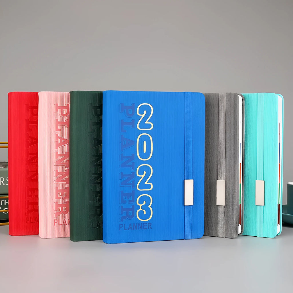 Student almanac calendar notebook with imitation leather cover showing wire-O binding and monthly design pages