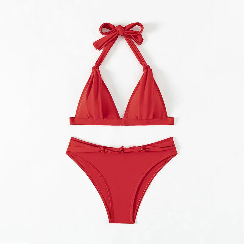 Red women's lace-up halterneck bikini with split shorts on mannequin