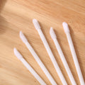Disposable lip brushes with flocked tips and black handles in multiple colours