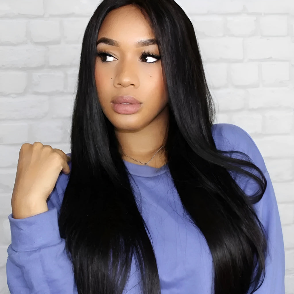 A woman wearing a long straight black wig with centre-parted bangs.