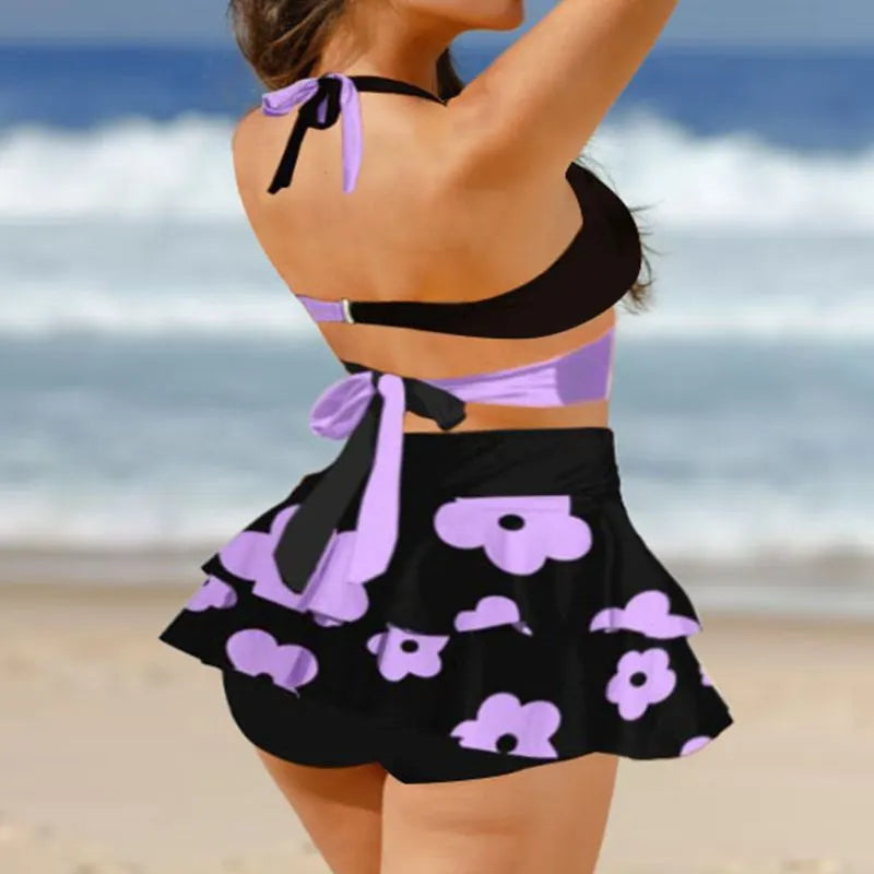 Women's purple lace-up high waist bikini set with matching swim skirt laid flat.