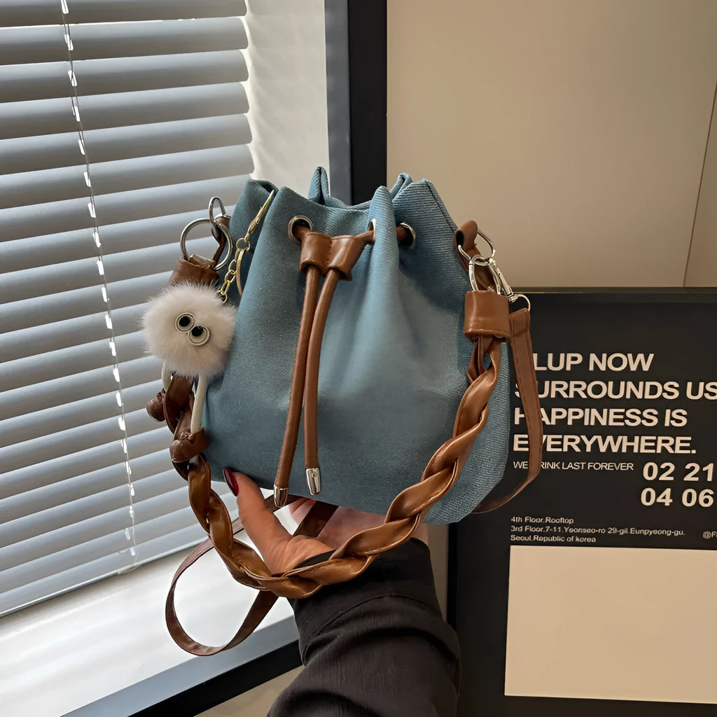 Blue synthetic leather cross body bucket bag with sandwich pocket organisation