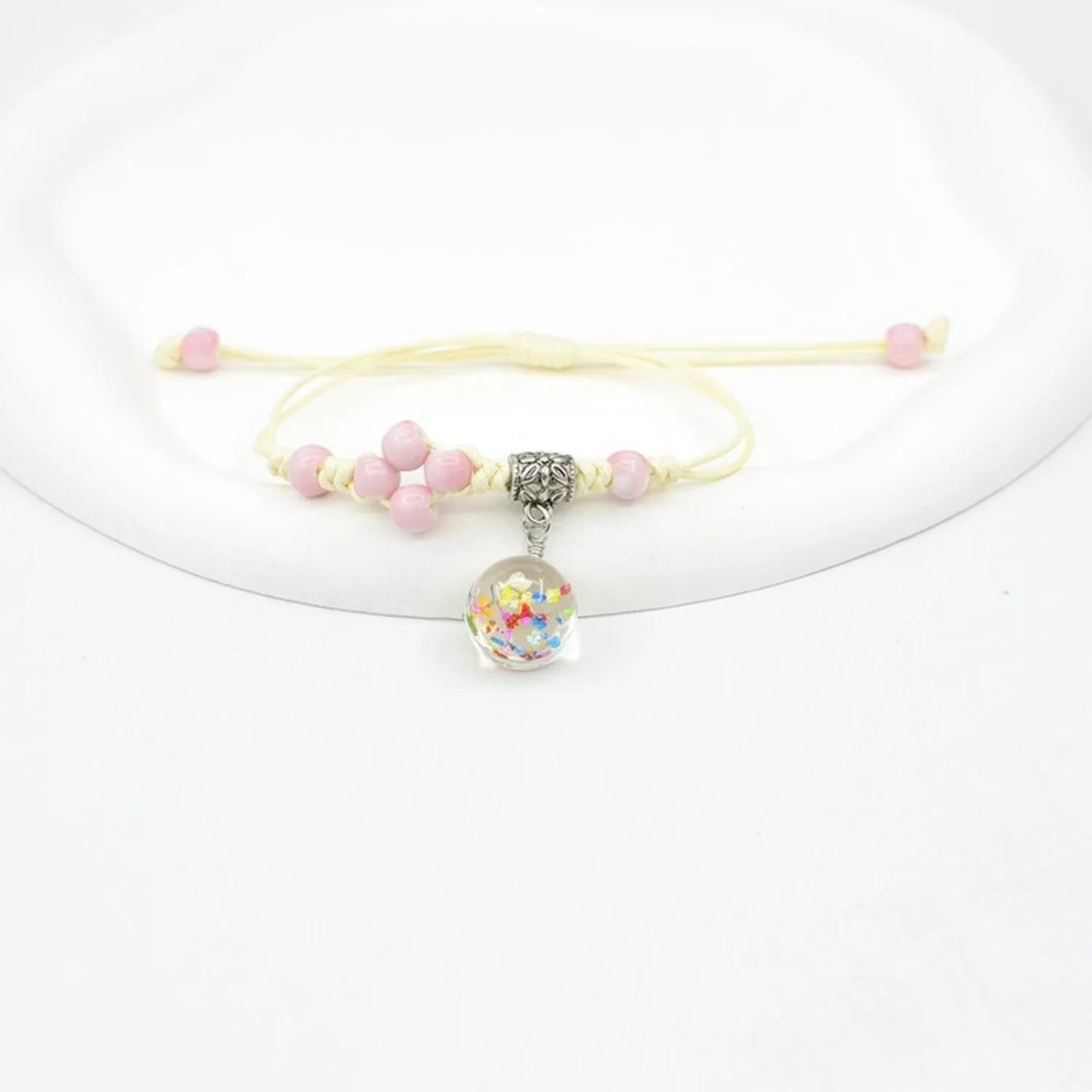 Women's hand-woven glass bracelet with large 1.4cm beads containing dried flowers, shown in blue colour option