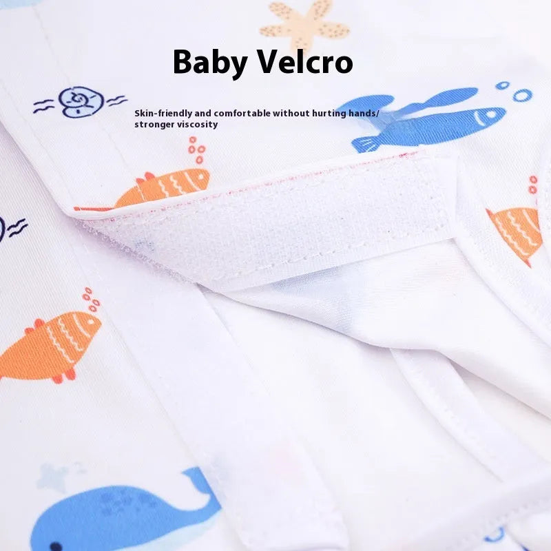 Cat wearing a blue patterned post-surgery sterilization recovery suit with Velcro closures.