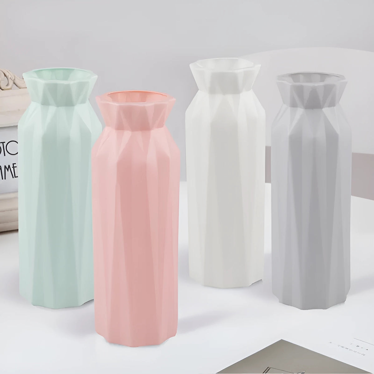 Simple green melamine plastic vase with a wide 7.2 cm base on a wooden table.