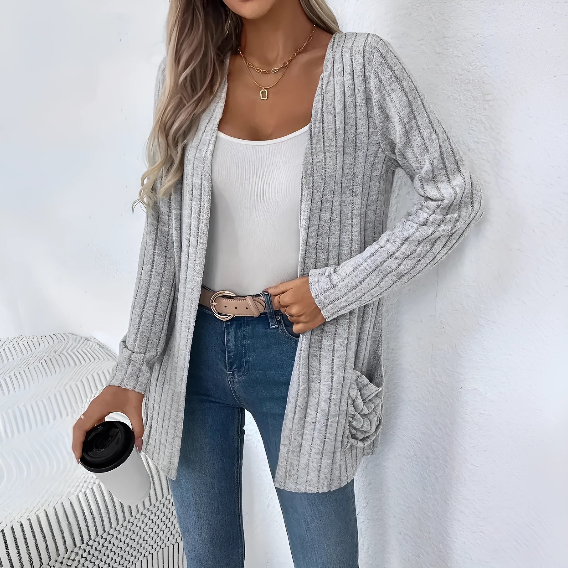 A solid colour long sleeve cardigan with pockets, shown in a loose fit on a model.