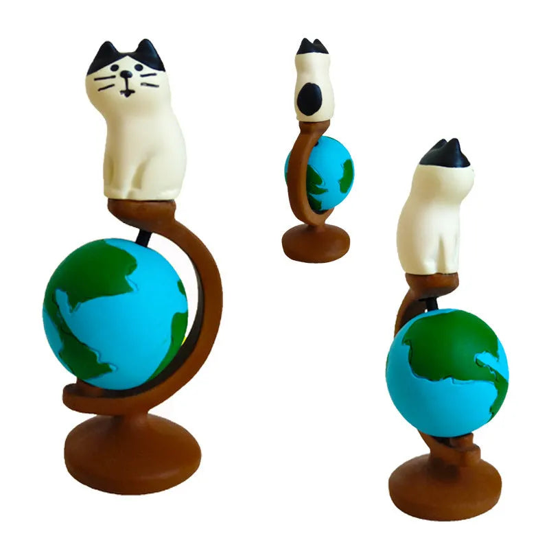 Cartoon cat resin figurine wearing Statue of Liberty crown and holding a globe, Earth Instrument Cat style.