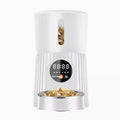 Black and white automatic pet feeder with food storage hopper and USB power connection