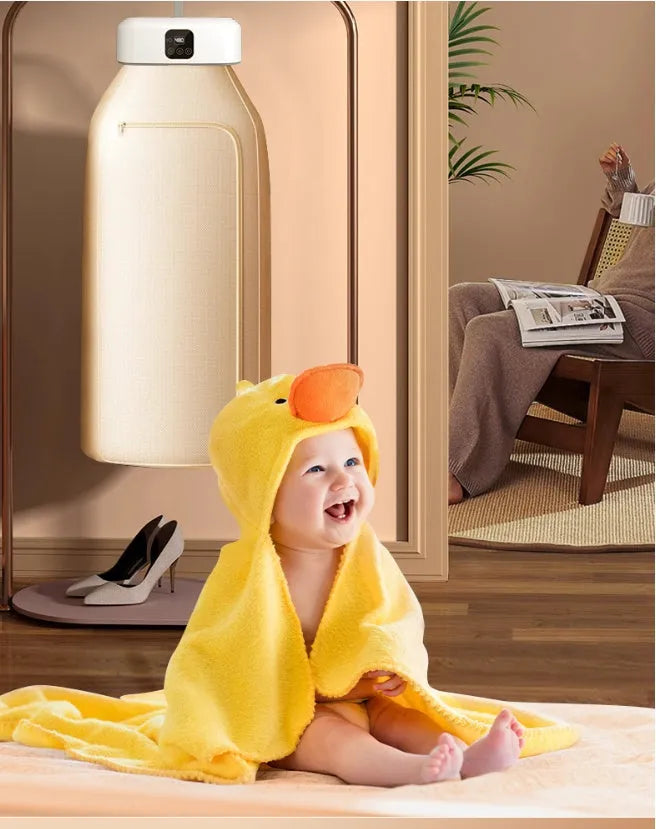 White cylindrical foldable clothes dryer with remote control on flat surface showing compact dimensions
