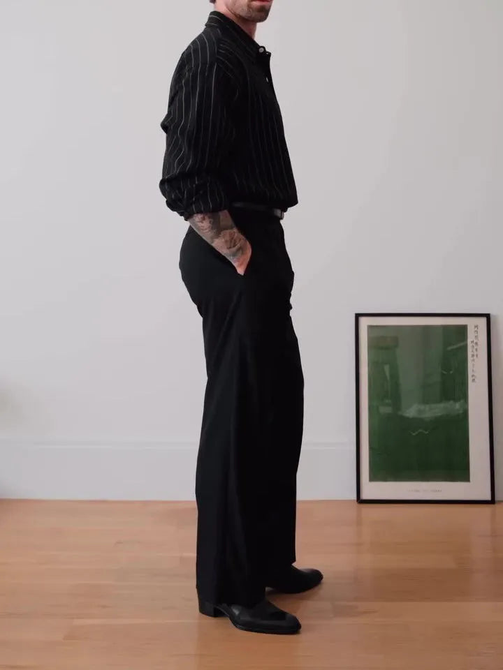 Black pinstriped polyester button-down shirt on a hanger showing regular fit