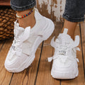 Women's purple platform mesh sports trainers with animal pattern and lace-up front on a white background.