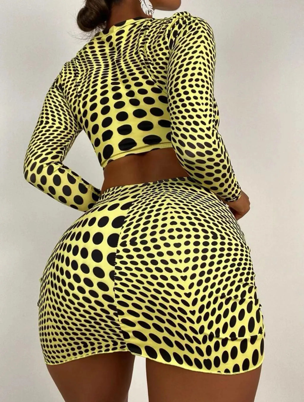 Women's green and yellow polka dot three-piece swimsuit set with top, skirt, and bra.