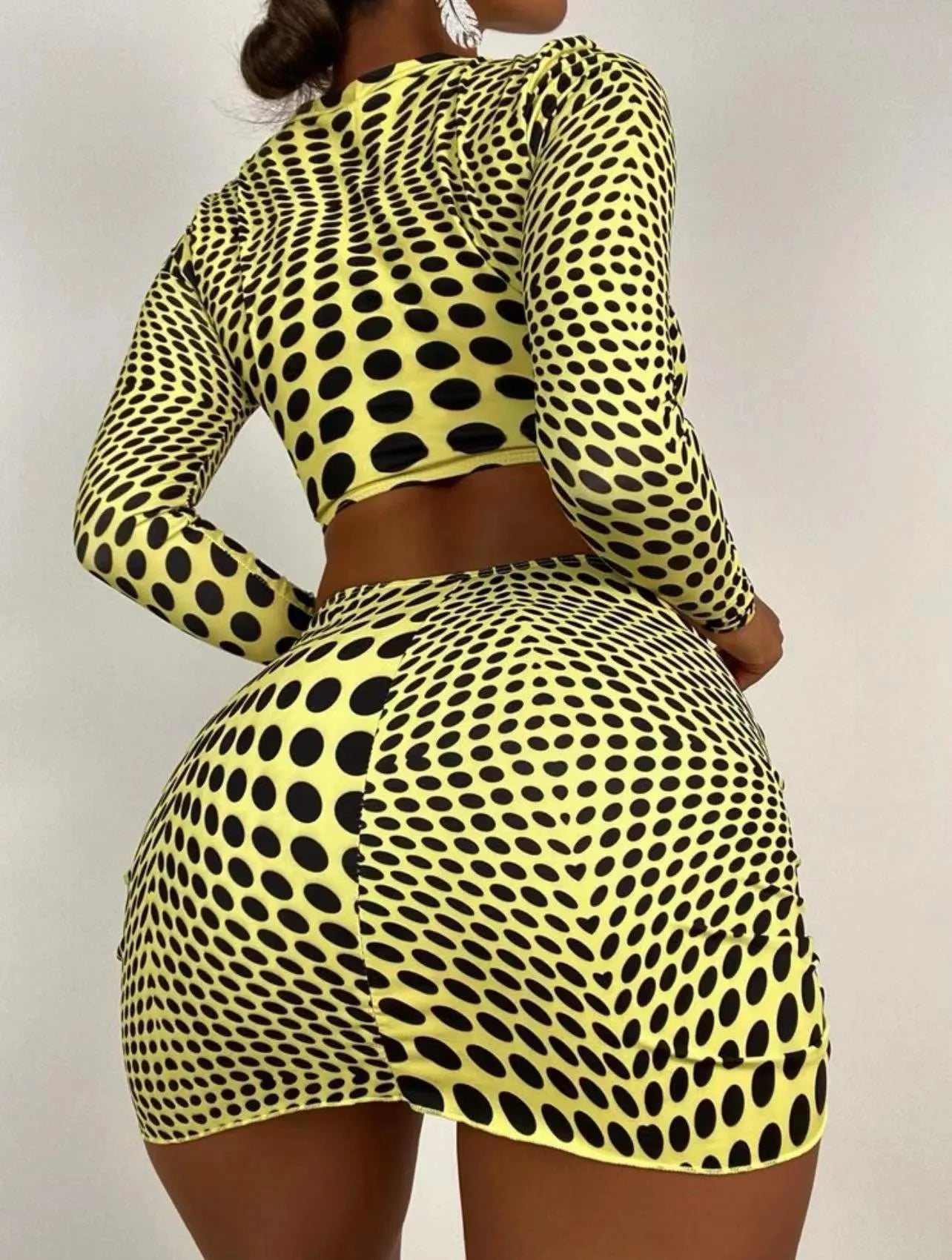Women's green and yellow polka dot three-piece swimsuit set with top, skirt, and bra.