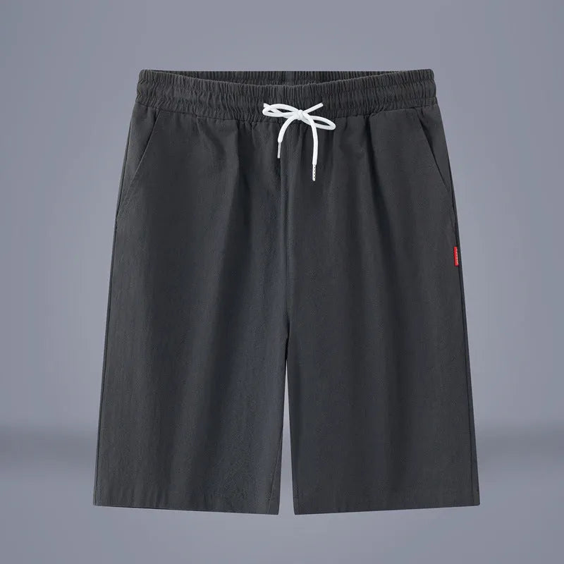 Man wearing solid colour cotton linen cropped trousers with a drawstring waist in a casual setting.