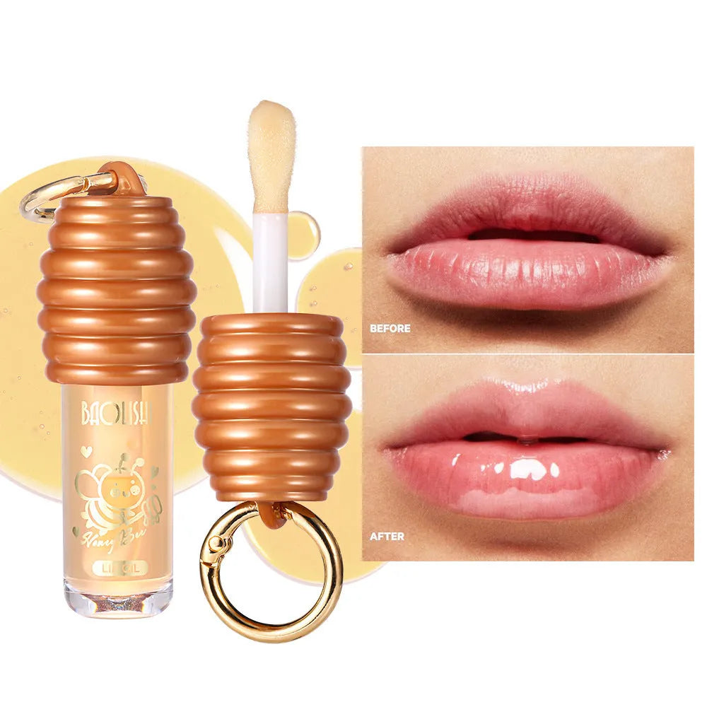 Portable honey lip gloss with keychain attached to bag strap