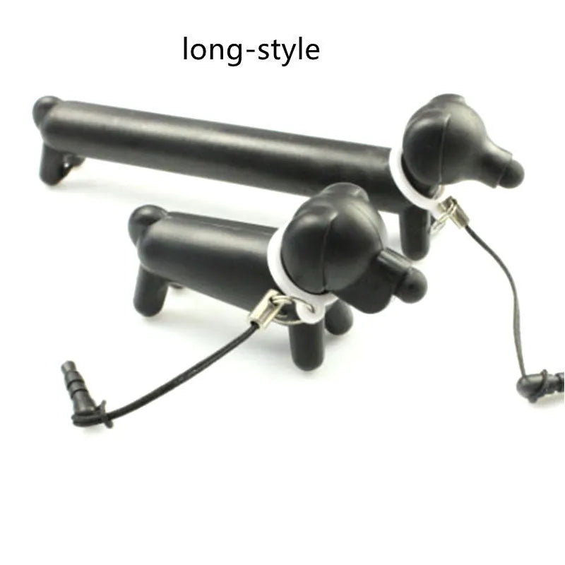 Black dog-shaped touch screen stylus pen shown next to a mobile phone on a desk.