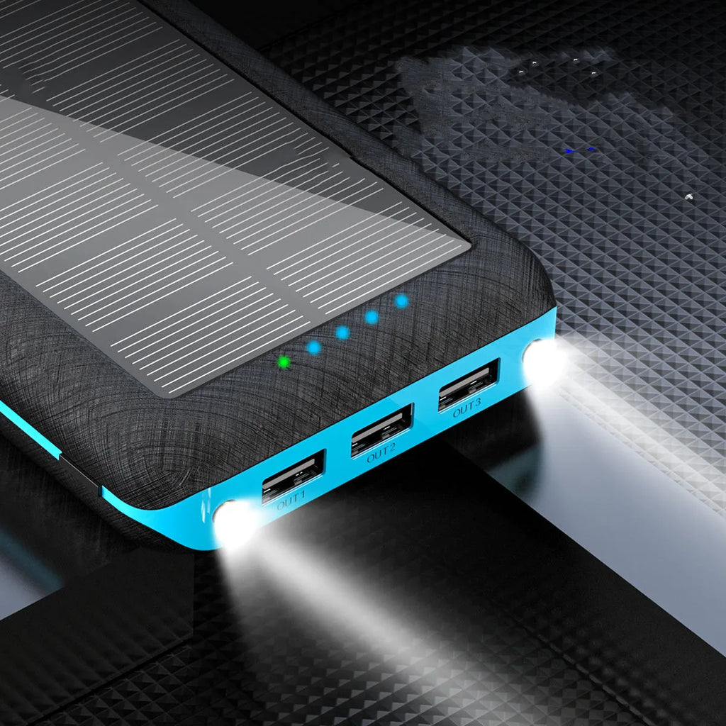 Black solar power bank with wireless charging pad, three USB ports, and an LED flashlight.