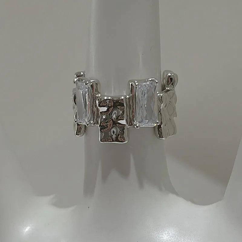 Silver geometric ring with cross zircon centre and open adjustable back