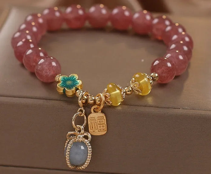 Red women's bracelet with strawberry quartz beads, alloy metal, and rhinestone detailing