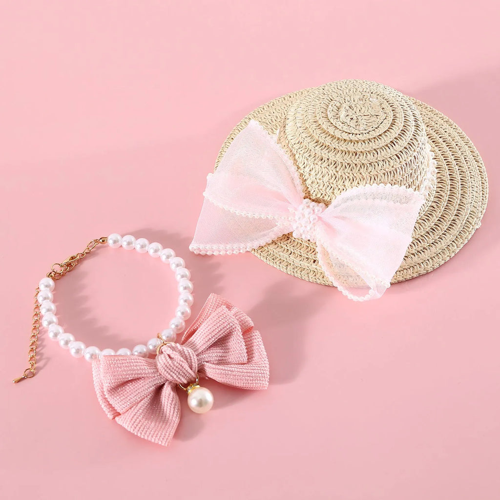 Pet cat wearing a woven Lafite leaf straw hat with a pearl butterfly decoration.