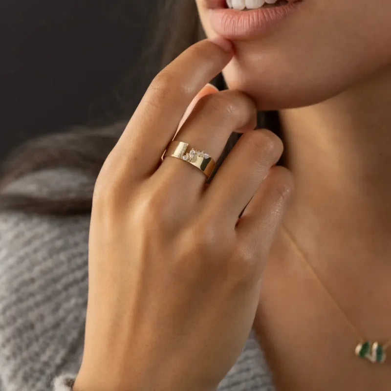 Gold electroplated women's ring with zircon detailing on a copper base, shown in size 8.