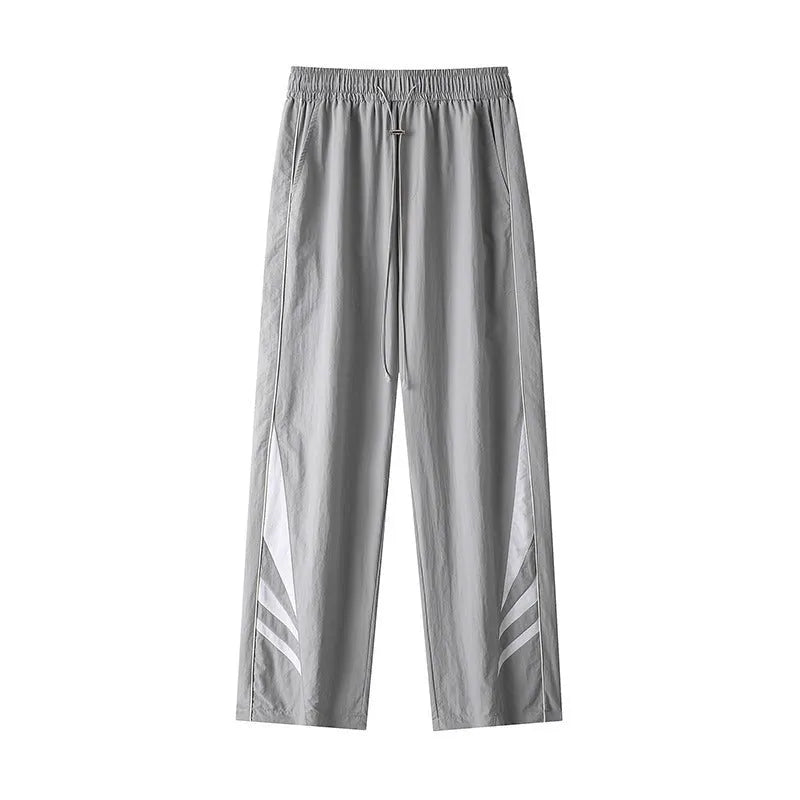 Men's straight-leg loose fit sports trousers in grey fabric with an elasticated waistband.