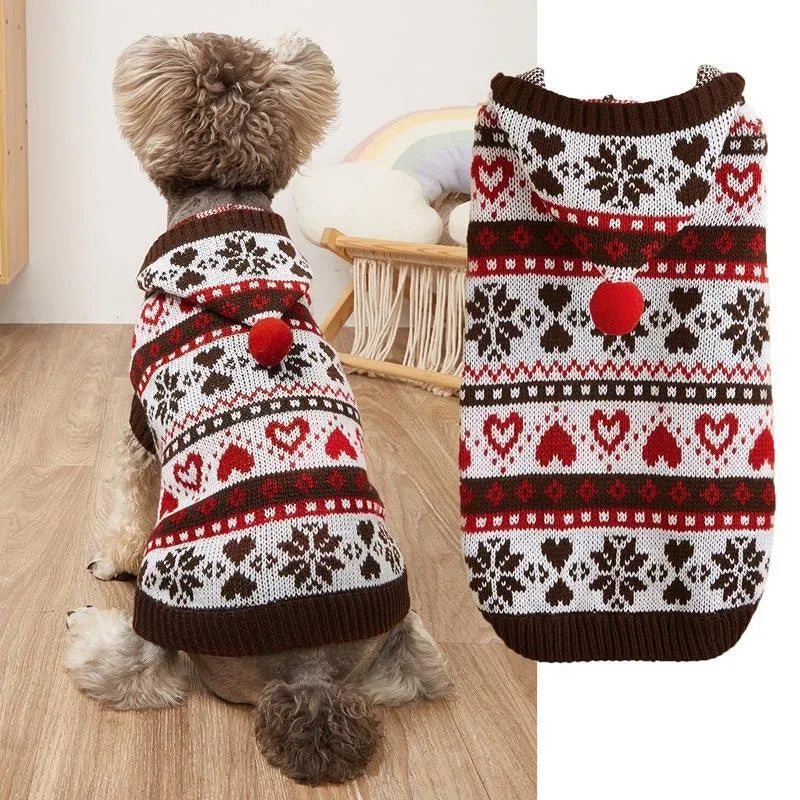 Colourful knitted dog sweater with snowflake and love heart patterns on a striped background.
