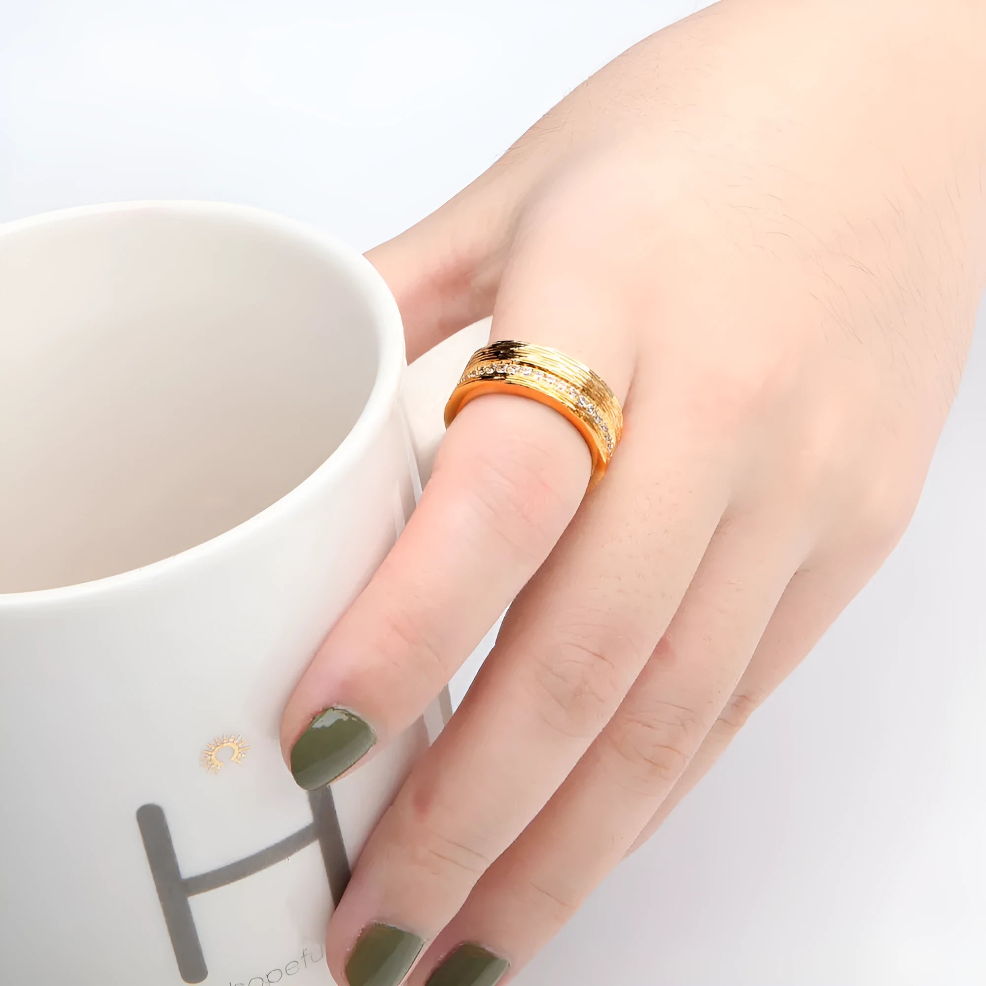 Geometric gold-coloured zircon ring for women showing detailed design and electroplated finish