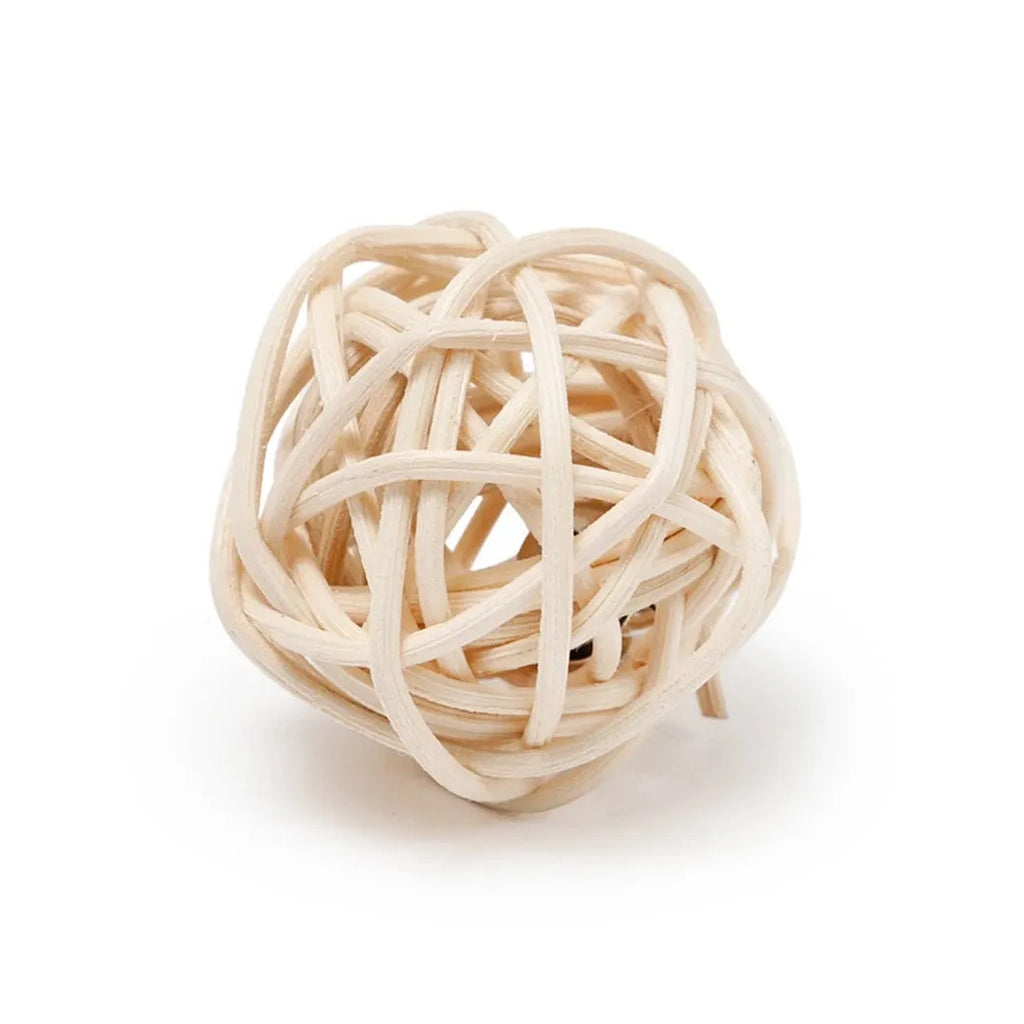 Two cat toys: a rattan ball with a bell and a faux feather ball on a plain background.