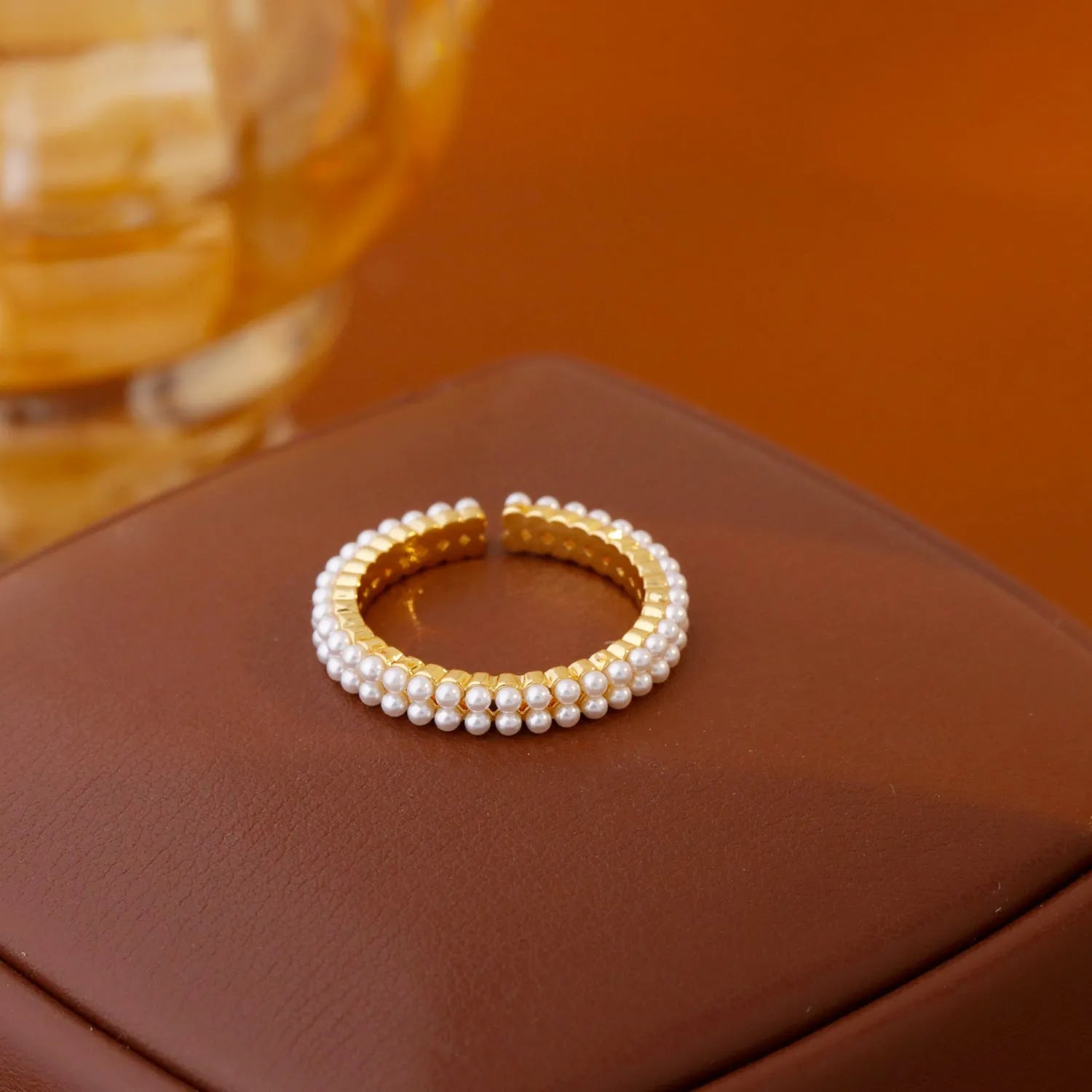 Geometric gold open mouth women's ring with round elements on female hand