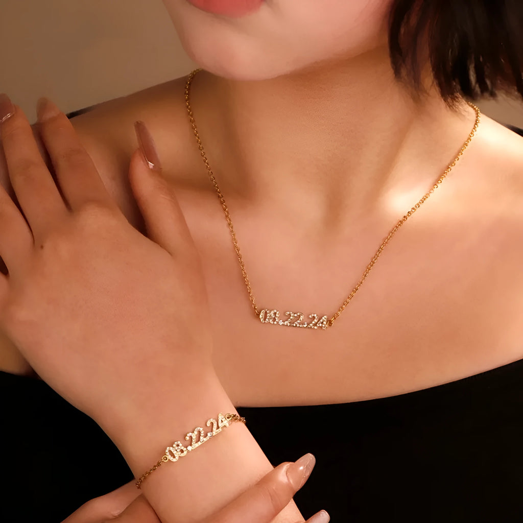 Stainless steel digital bracelet or necklace with diamond-set bezel showing time display, in gold, rose gold, or steel finish.