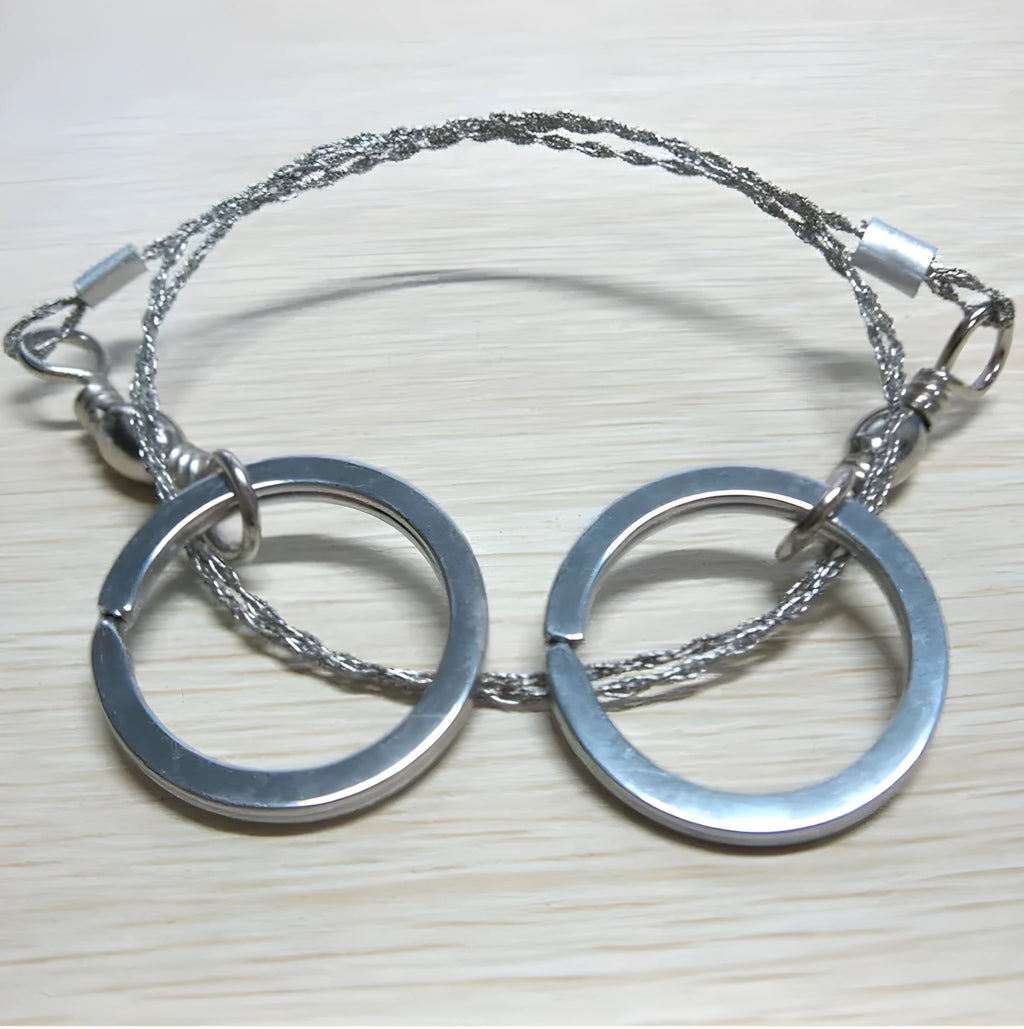 Stainless steel survival wire saw with pull rings showing 55cm cutting length