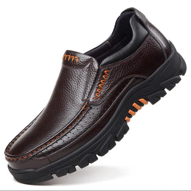 A pair of black and brown business casual leather shoes with a rubber sole, shown from the side.