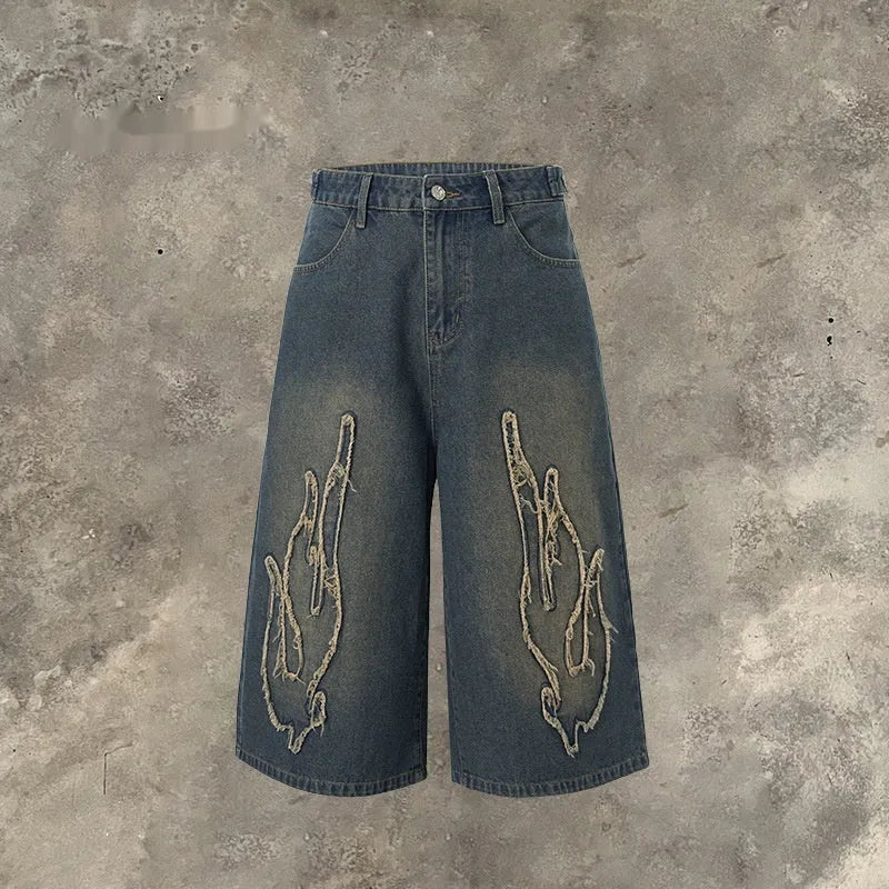 Men's black denim shorts with flame embroidery detail on straight-leg cut
