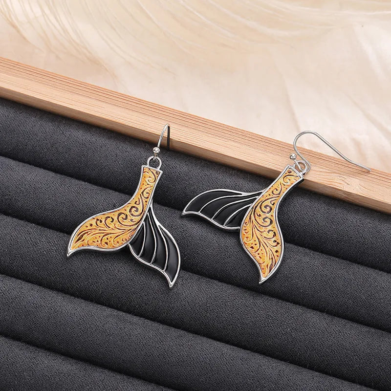 Women's white gold colour fishtail earrings with retro whale design elements