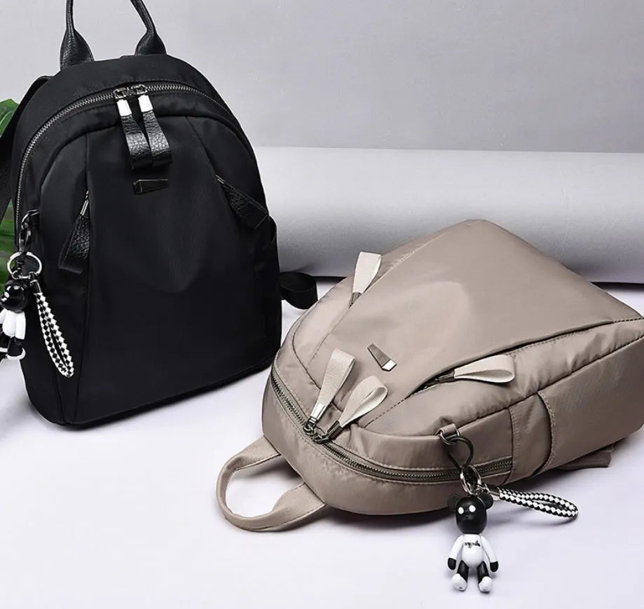 Medium Oxford cloth rucksack in wine red colour showing internal compartments and shoulder straps