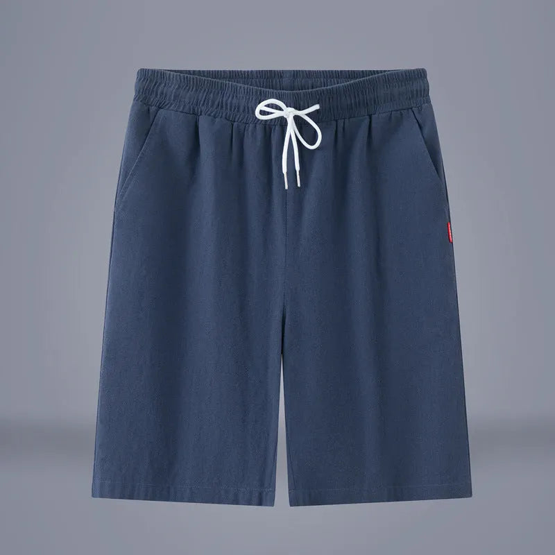 Man wearing solid colour cotton linen cropped trousers with a drawstring waist in a casual setting.