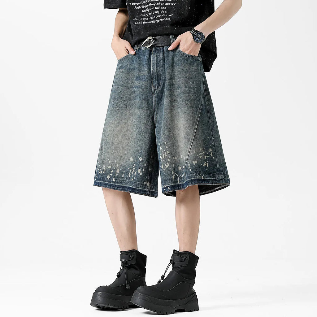 Men's retro blue denim shorts with ripped detailing and splash ink patterns on straight leg cut