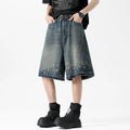 Men's retro blue denim shorts with ripped detailing and splash ink patterns on straight leg cut