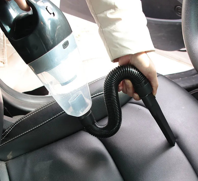 Portable orange handheld car vacuum cleaner with nozzle attachments