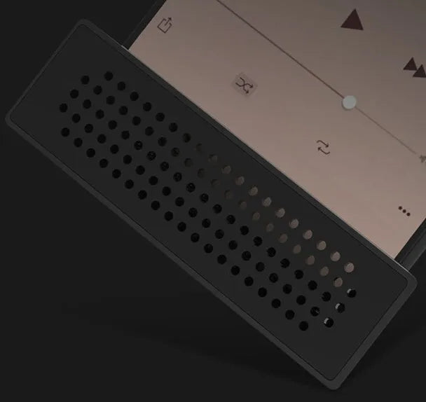 Pink portable ABS mobile phone amplifier bracket holding a smartphone horizontally on a desk.