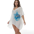 White plus size loose beach cover-up blouse on a hanger.